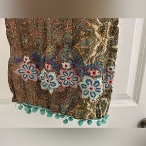 Paisley scarf with embroidery and pom poms.